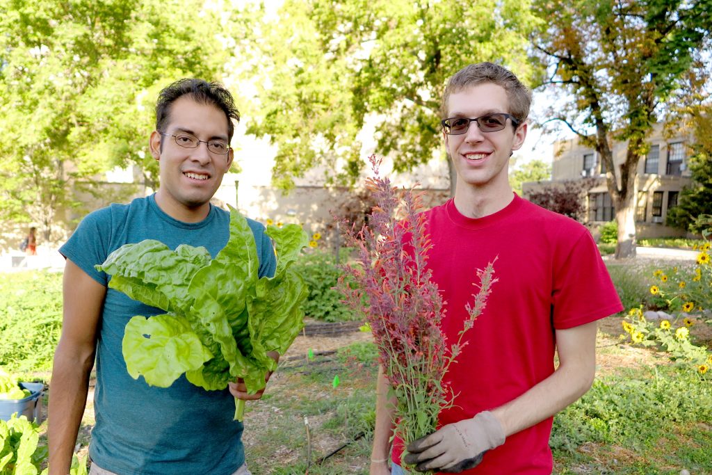University of Utah students holding what they harvested from the Edible Campus Garden