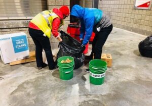 Two volunteers sort through food waste after an October 2019 University of Utah Football Game.